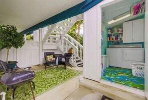 Cozy retreat with a seating area, staircase, and compact kitchen.