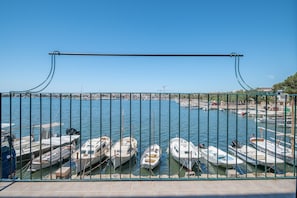 Boats docked in a serene marina, surrounded by a town with buildings.