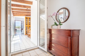 Enjoy a peaceful retreat with an outdoor access, comfortable seating area, and a convenient cabinet for storage.