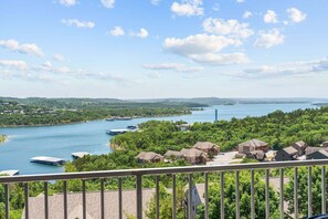 A residential area with houses, a dock, and a lake. - Luxury & Spacious Condo with Fantastic Lake Views Near Silver Dollar City w Free Tickets (Branson)