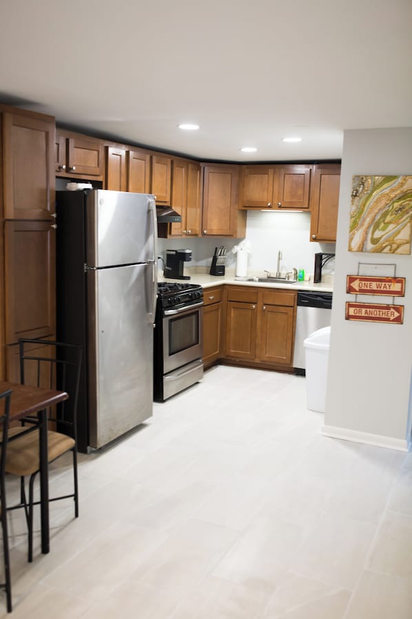 Enjoy cooking in this fully equipped kitchen with a refrigerator, stove, and dishwasher.