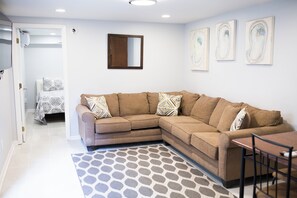 Relax in this stylish living room with a comfortable sofa, coffee table, and dining area.