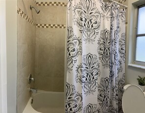 Combined shower/bathtub, hair dryer, towels, soap