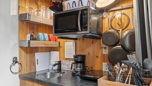A kitchen with a microwave, coffee maker, and various utensils. - Romantic, Peaceful Getaway; Within 10 Mi of Mt. Rushmore & Custer State Park  (Keystone)