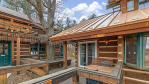 A log cabin-style building with a wooden deck, a covered seating area, and a sign reading 'MASTER SUITE'. - Romantic, Peaceful Getaway; Within 10 Mi of Mt. Rushmore & Custer State Park  (Keystone)