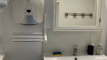 Bathtub, hair dryer, towels, soap