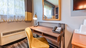 A hotel room with a wooden desk, a telephone, a mirror, and a window with curtains. - La Mirage Inn - Hollywood (Los Angeles)
