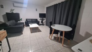 Superior Apartment | Living area | 48-inch Smart TV with cable channels, TV - Emthree Seaside Apartments (North Ward)