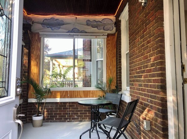 Enjoy a meal or social gathering in this inviting room with a brick wall and window offering a view of the outside.