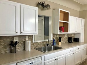 Enjoy cooking in this well-equipped kitchen with a stainless steel sink, dishwasher, and coffee maker.