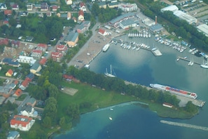 An aerial view of a marina with boats, a dock, and surrounding buildings.