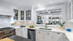 A modern kitchen with white cabinetry, a stainless steel stove, and a dishwasher. - Center Of It All: 454-Cv  Sea Captain's Estate with Heated Pool and Pickle Ball Court (Centerville)