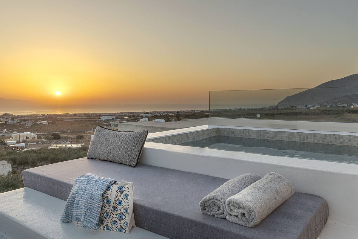 Une terrasse ensoleillée avec vue sur la mer et une piscine.