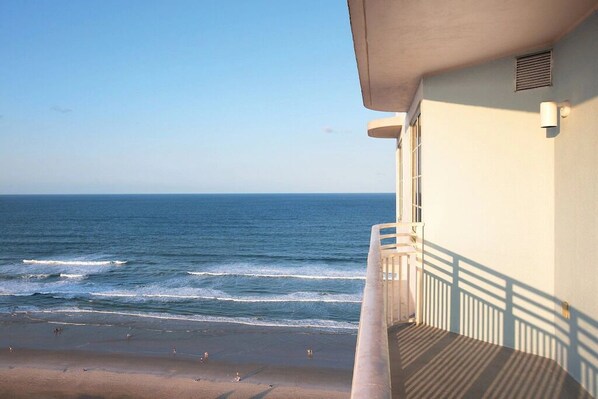 A balcony with a view of the ocean.