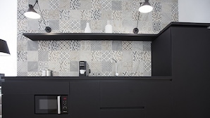 A modern kitchen with a microwave, coffee maker, and a patterned backsplash. - Appartamento Anice A: A welcoming apartment situated in a central location, at a short distance from the main tourist attractions of the city, with Free WI-FI. (Trapani)