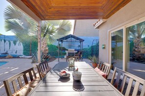 An outdoor patio with a table, chairs, a grill, and potted plants. - Family Home w/ Community Perks in Peoria (Peoria)