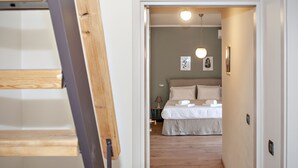 Un dormitorio con cama, mesita de noche y lámpara.
