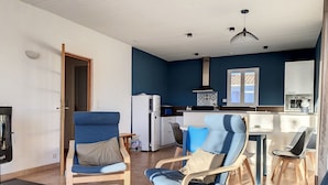 A compact living space with a kitchenette, a dining area, and seating arrangements.