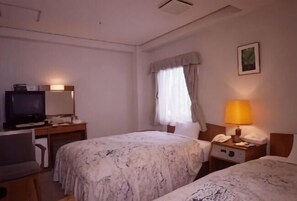 A hotel room with two beds, a desk with a television, a lamp, and a telephone. - Okayama Ekimae Universal Hotel (Okayama City)