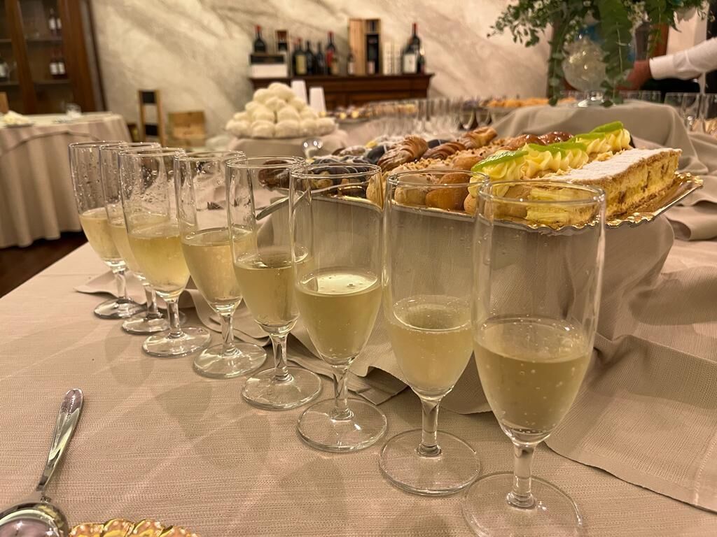 A table with champagne glasses and a variety of desserts.