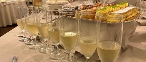 A table with champagne glasses and a variety of desserts.