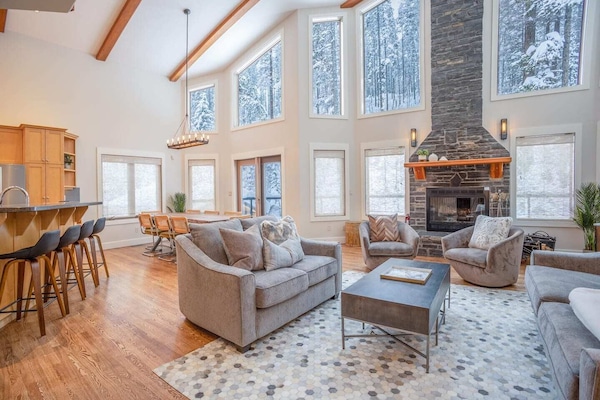 Living to dining to peninsula breakfast bar. An incredible area to hang out. Complete with wood-burning stove.