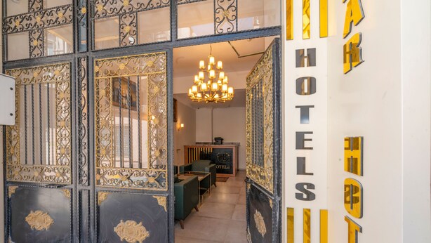 A hotel lobby with a chandelier, seating area, and a reception desk. - Bazaar Hotels Old City (Istanbul)