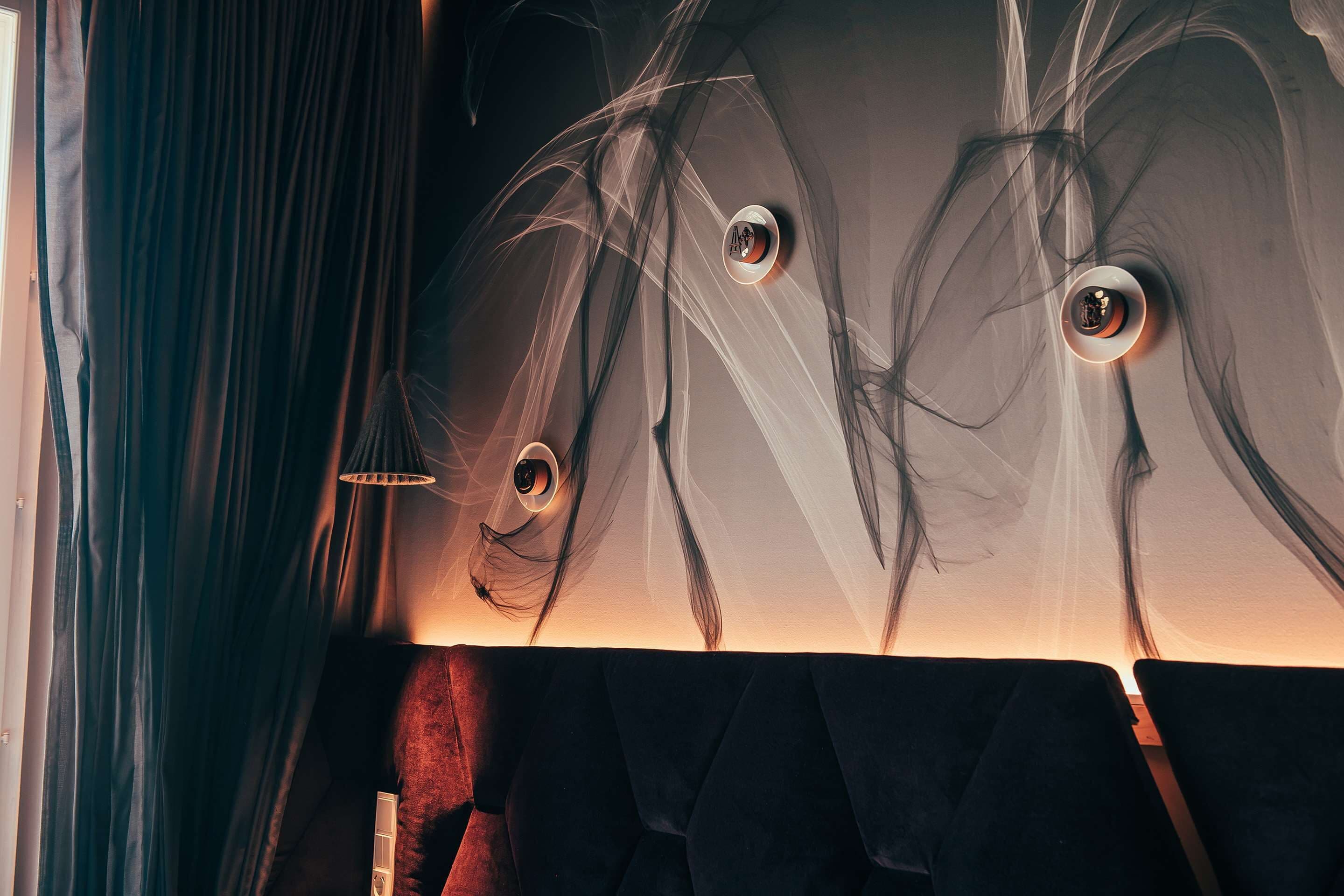 A room with a dark, textured wall and a window with curtains.