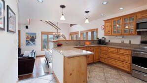 A spacious kitchen with wooden cabinets, a granite countertop, and a stainless steel oven. - Pet Friendly Home at Purgatory - Decks with Amazing Views - Steps to Lifts (Durango)