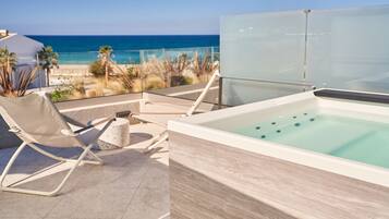 A rooftop terrace with a spa tub and lounge chairs overlooking a beach.