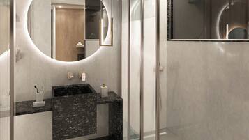 A modern bathroom with a curved vanity, a large mirror, and a glass shower enclosure.