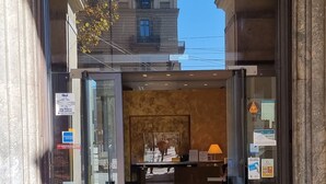 The entrance to Hotel Bologna with a reception desk visible inside. - Hotel Bologna (Turin)