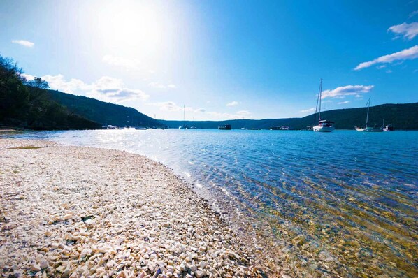 On the beach, sun-loungers