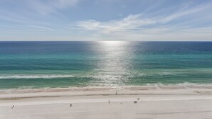 A beach with a clear sky and calm sea.