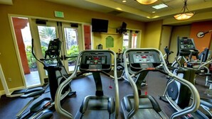 A gym with treadmills, ellipticals, and weight machines.