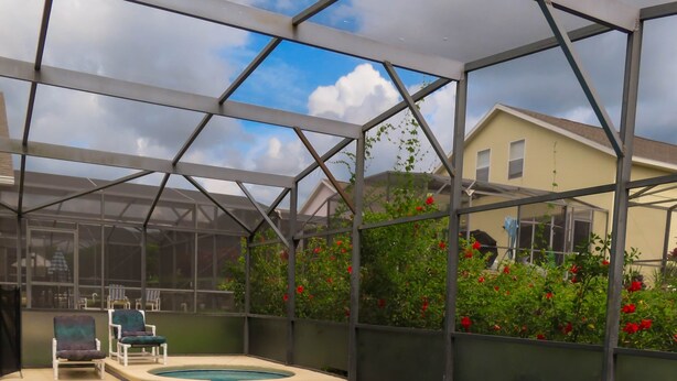 A swimming pool with a glass enclosure, lounge chairs, and a view of a house. - The Glenbrook Getaway – 4BR Resort Home with Pool & Spa (Four Corners)