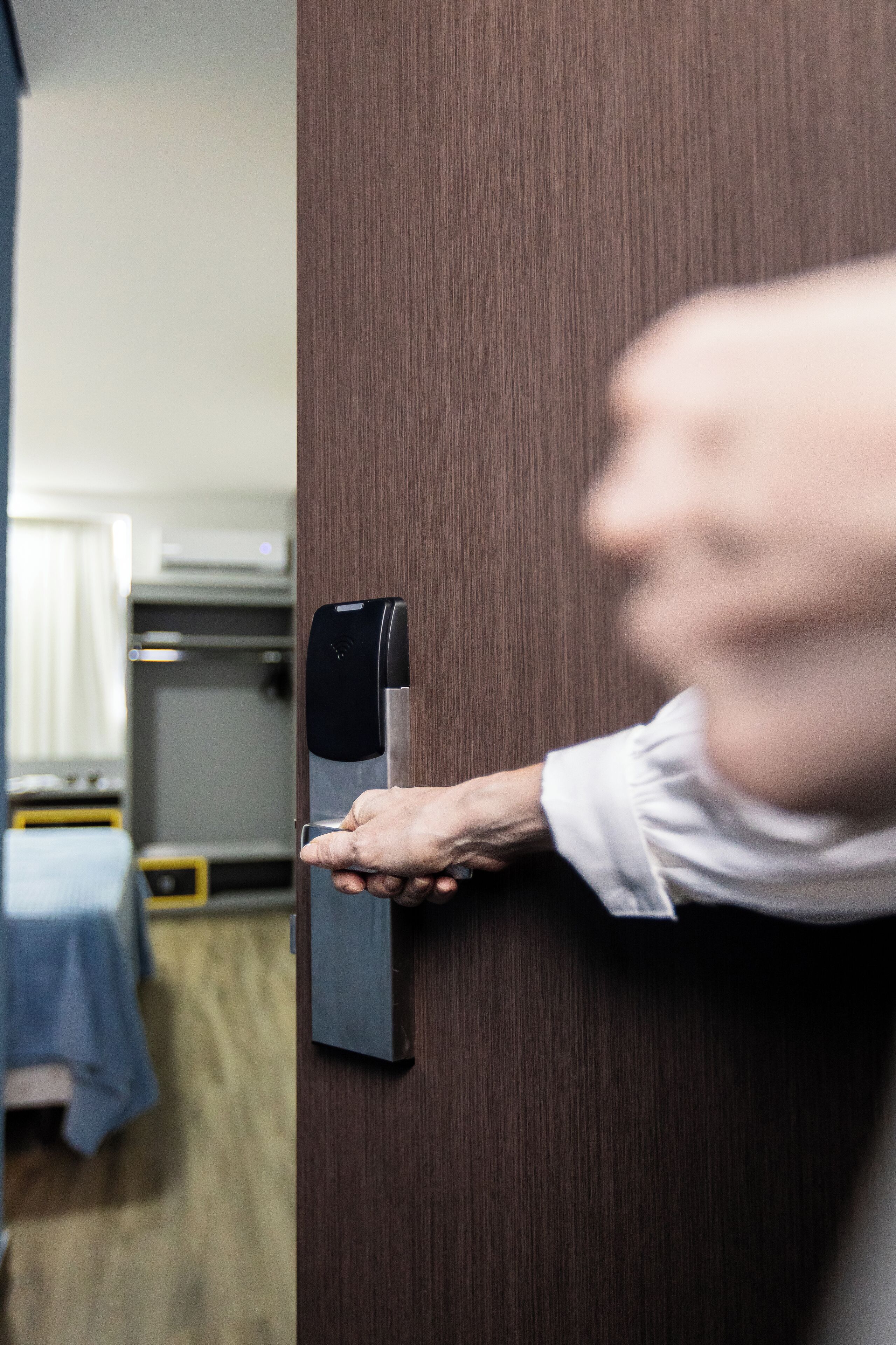 A person using a modern door lock mechanism.