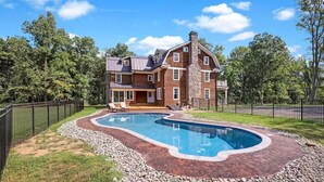 A two-story house with a swimming pool.