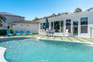 A heated pool, sun loungers