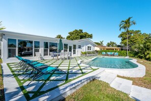 A heated pool, sun loungers