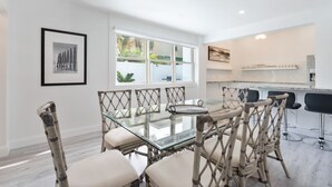 A modern kitchen with a glass island and bar stools. - 4/5 for 8, Steps to Beach-Jacuzzi, Furnished Patio (Hollywood)