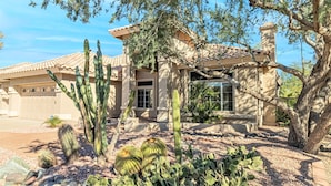 A house with a tiled roof, a garage, and a garden with various cacti. - Gardenesque oasis getaway w/cooling water misters (Phoenix)
