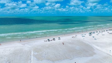 Beach nearby, white sand, beach towels