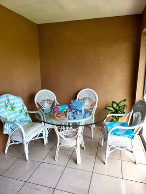 Relax in this intimate outdoor seating area with a round table and four comfortable chairs.
