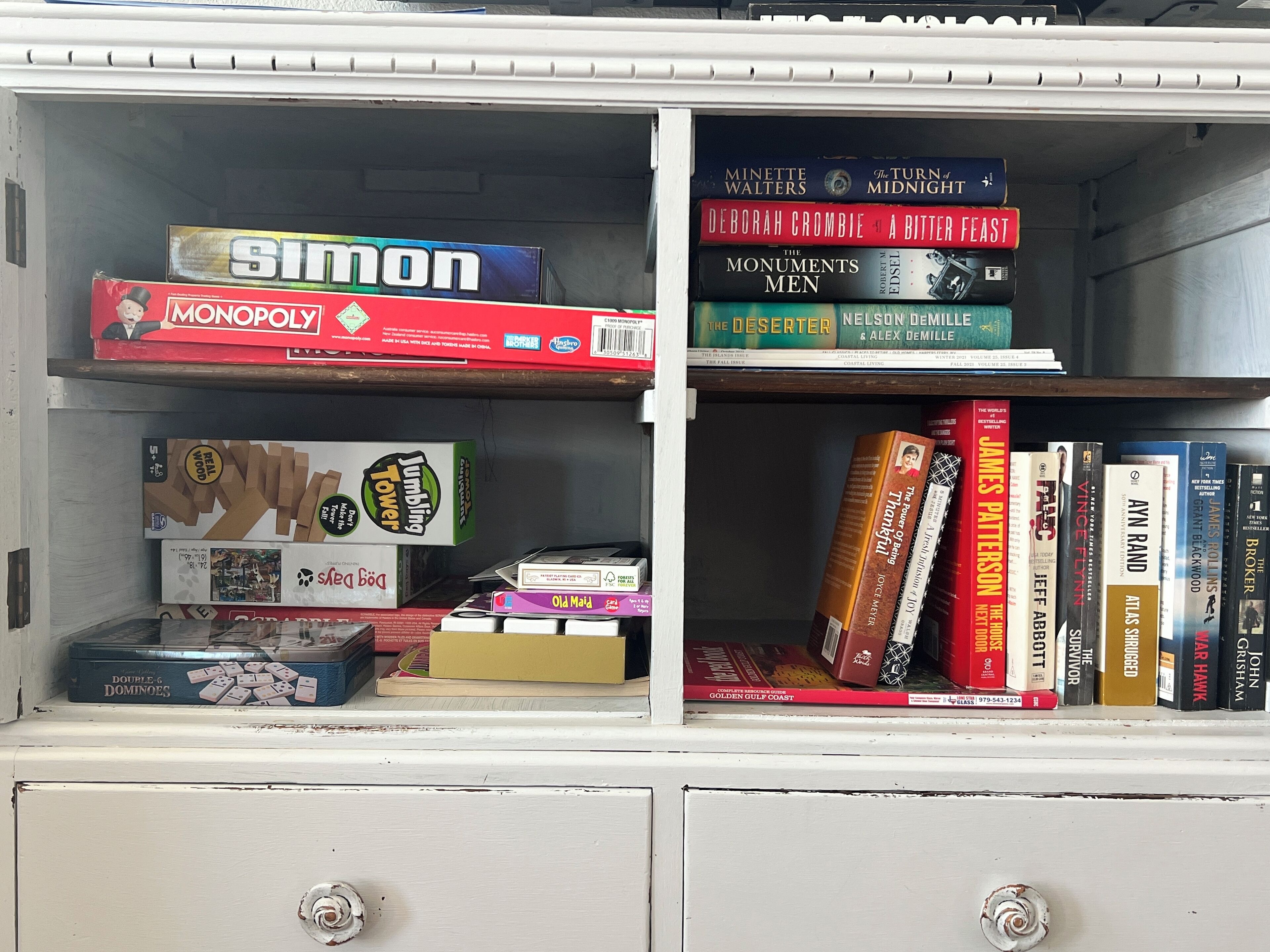 A bookshelf with various books and board games.