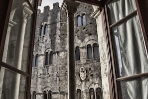 A historic building with arched windows and a central emblem.
