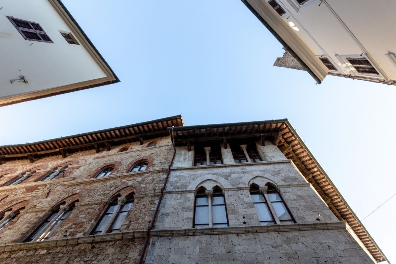 A historic building with arched windows and a stone facade.