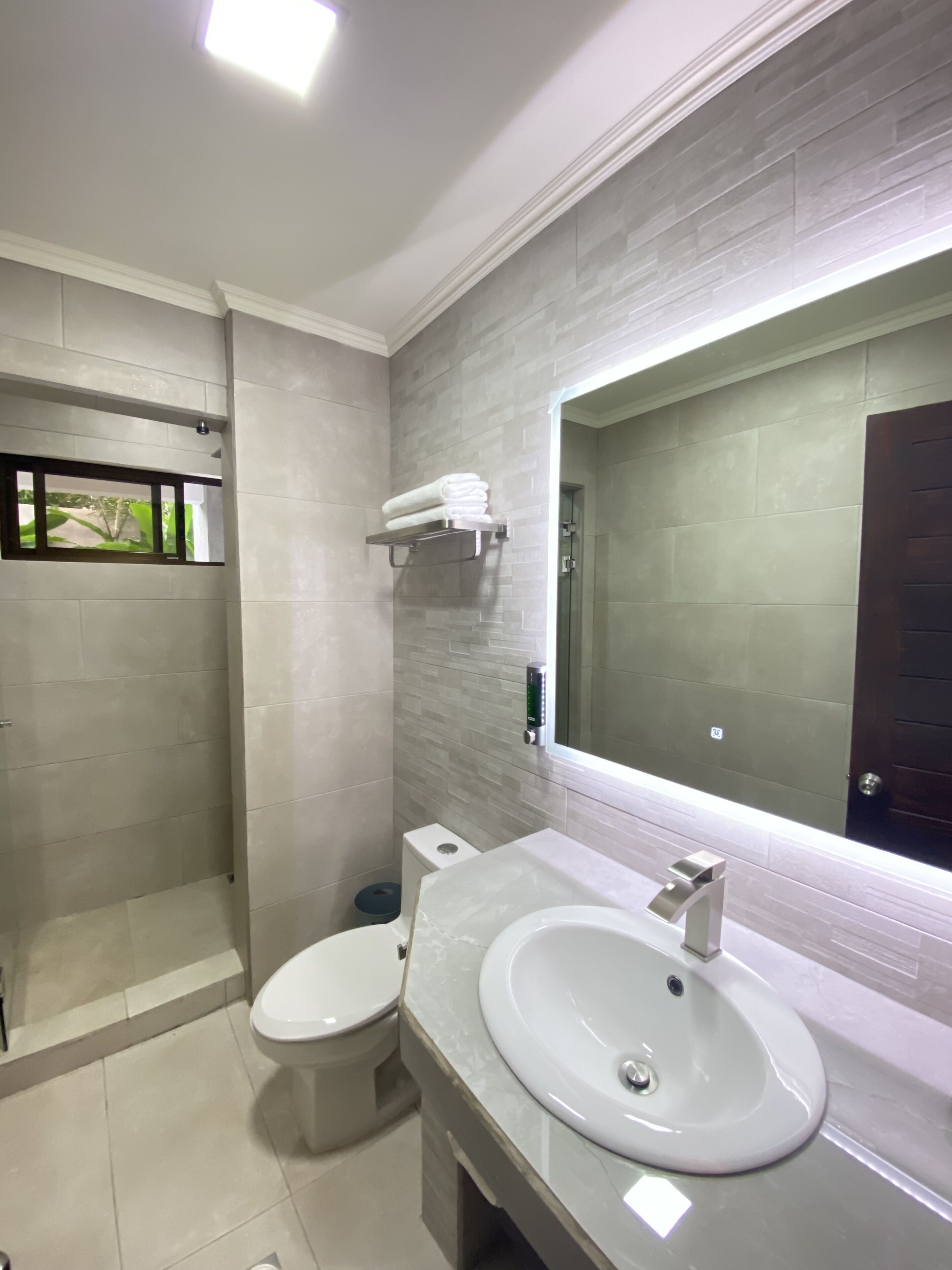 shower, rainfall showerhead, hair dryer, towels