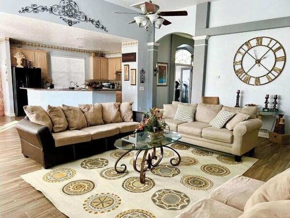 Relax in this inviting living room with a leather sofa, coffee table, and decorative ceiling light.
