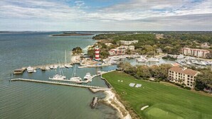 An aerial view of a coastal area with a marina, a lighthouse, and a golf course. - RESTFUL RETREAT! (Hilton Head Island)